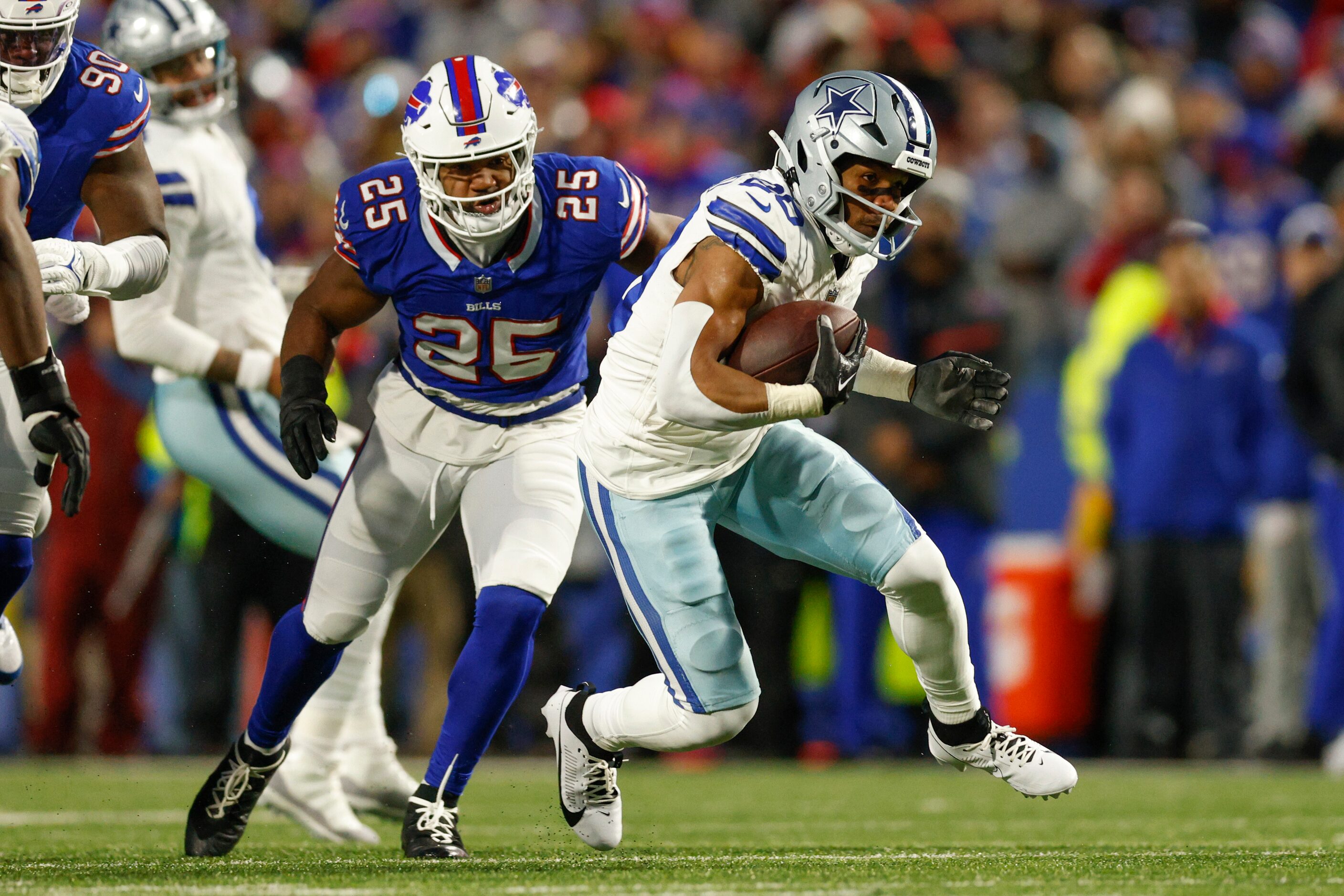 Dallas Cowboys running back Tony Pollard (20) runs the ball past Buffalo Bills linebacker...