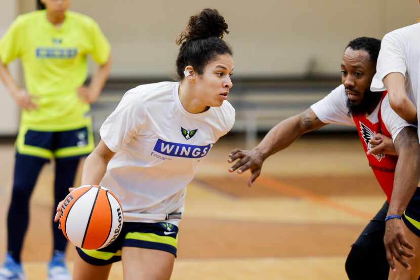 Dallas Wings top draft pick Veronica Burton dribbles during a training camp practice on...