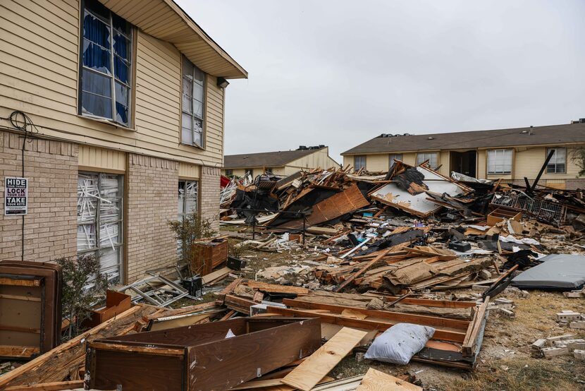 Debris still littered the site of an explosion at the Highland Hills Apartments a day after...