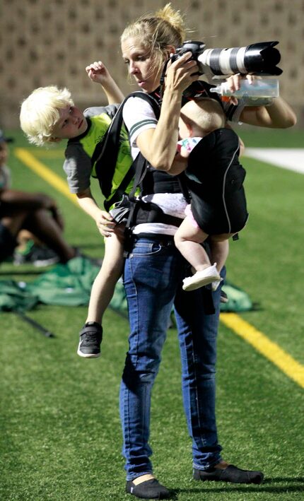 Photographer Melissa Wardlow multitasks, talking with 3-year-old son Jordan and feeding...