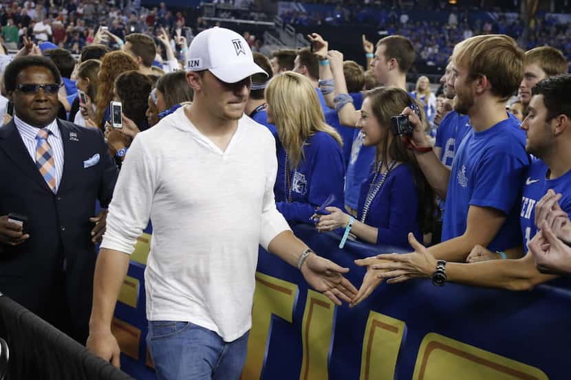 Johnny Manziel greets fans during halftime as the Kentucky Wildcats faced the Wisconsin...