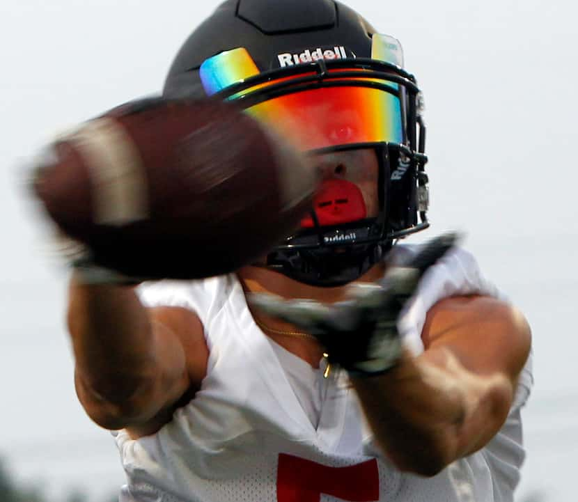 Argyle receiver Hayden Stewart (5) reaches for a pass during an opening day position drill....