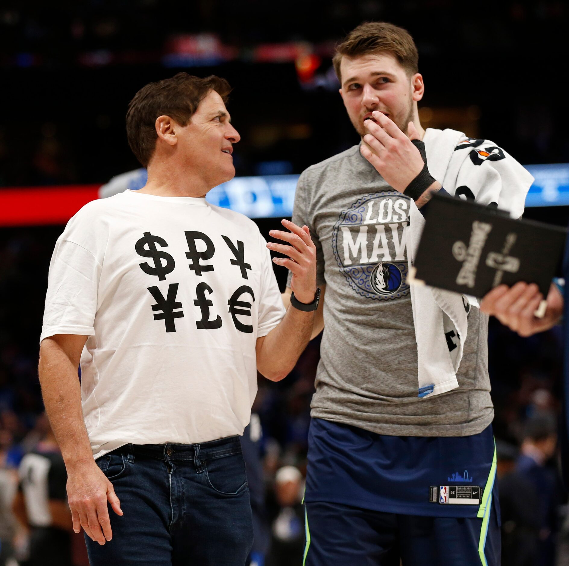 Dallas Mavericks owner Mark Cuban sports a shirt with money signs as he talks to Dallas...