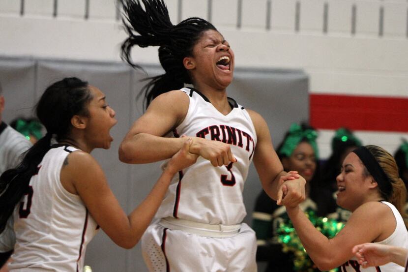 Euless Trinity guard Trinity Oliver (3) screams for joy as she is joined by teammates Tahnia...