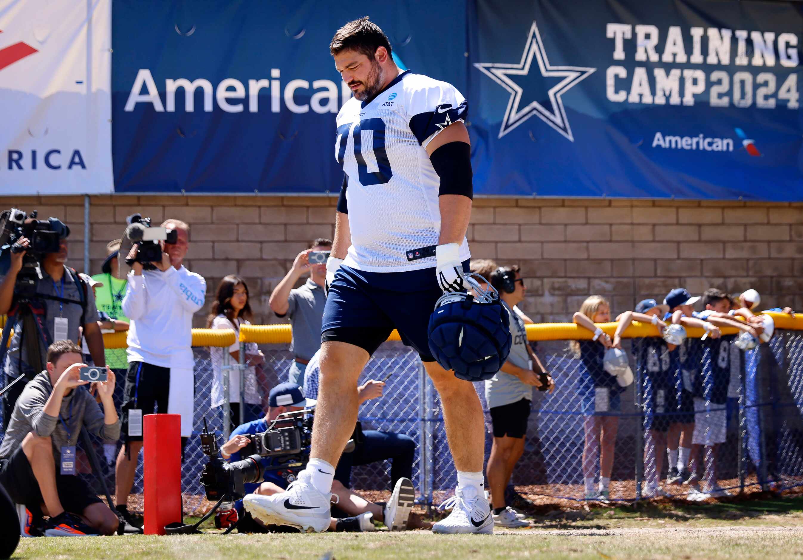 Dallas Cowboys guard Zack Martin (70) walks to the practice fields for the start of a...