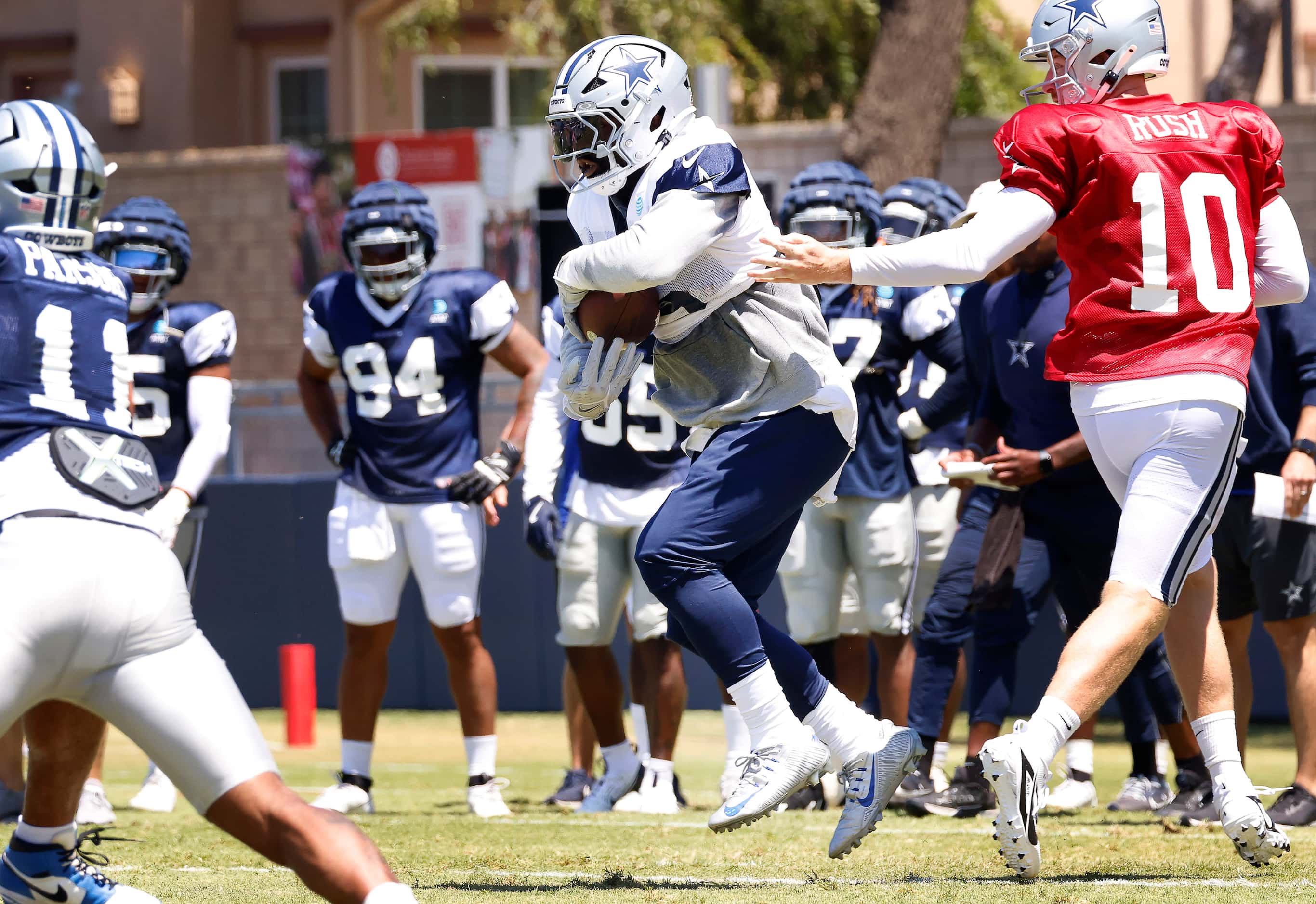 Dallas Cowboys running back Ezekiel Elliott (15) leaps as he receives the handoff from...