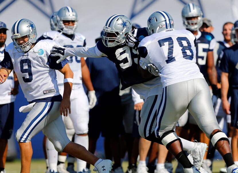 Dallas Cowboys tackle Cameron Bradfield (78) can't keep defensive end Ryan Russell (99) from...