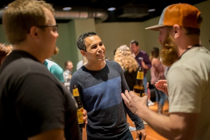 Nathan Hanks, CEO and co-founder of MAX (center), chats with fans at a private...