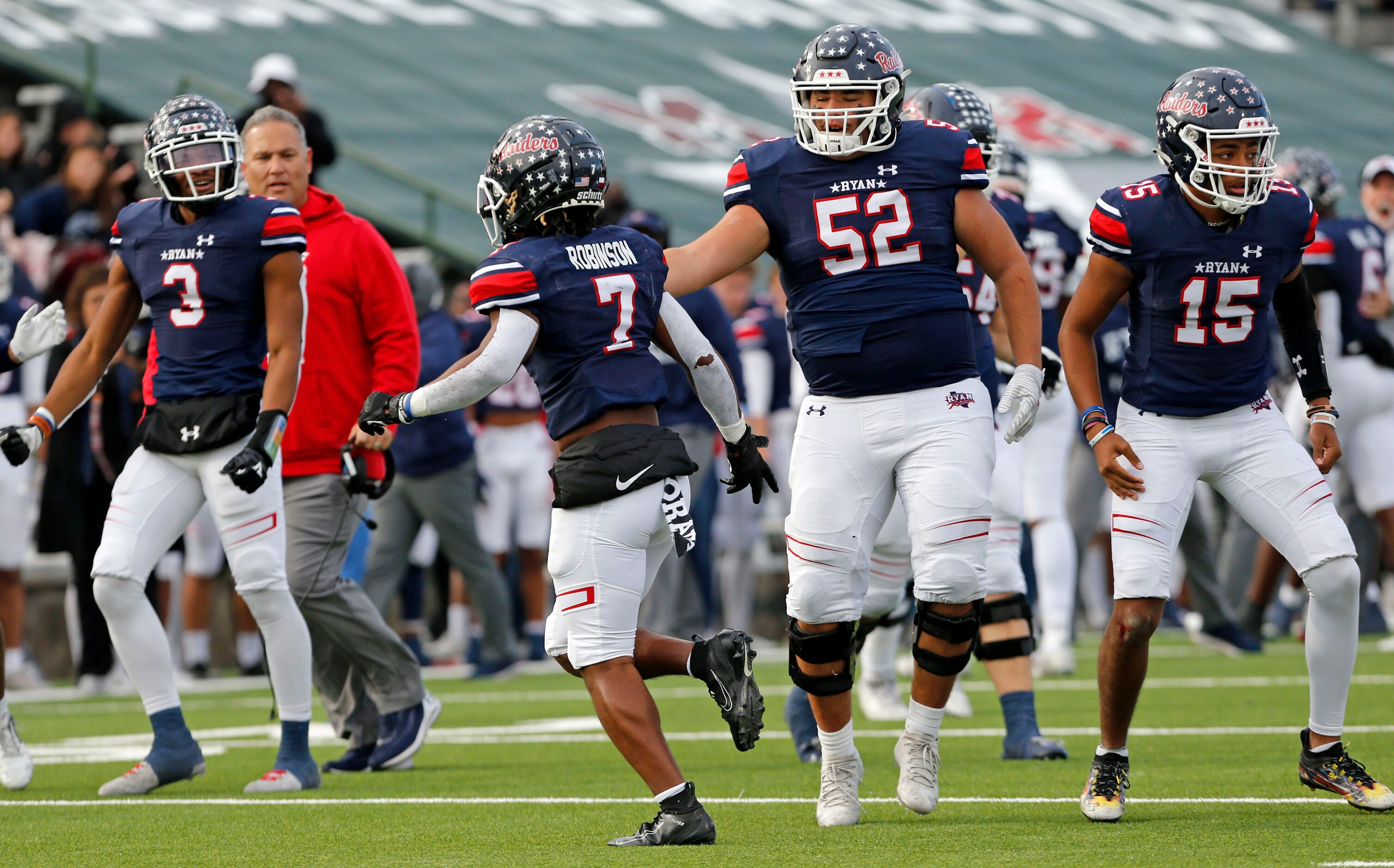 Denton Ryan DB Garyreon Robinson (7) is congratulated by teammates, including Bryan Buckett...