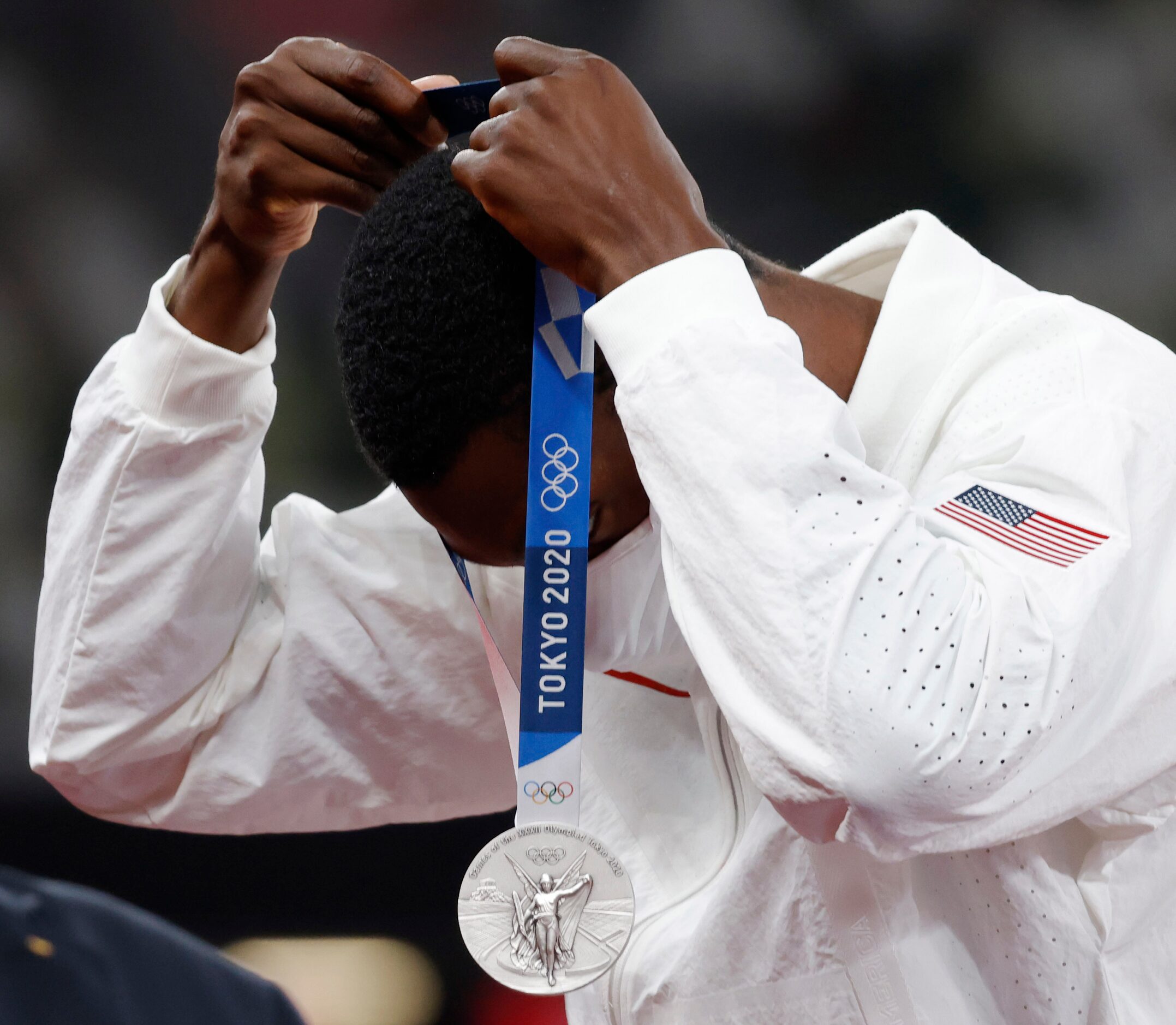 USA’s Fred Kerley puts the silver medal he earned for his 9.84 second finish in the men’s...