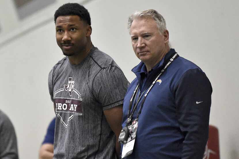 Former Texas A&M defensive end Myles Garrett, left, looks on during Texas A&M Pro Day at the...