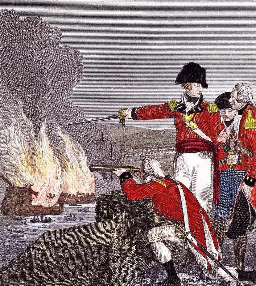 British officers, one with a telescope, watch enemy vessels burn during the siege of...