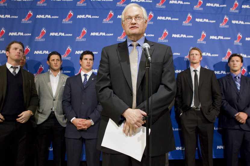 Donald Fehr, left, executive director of the NHL players' association, talks to reporters...