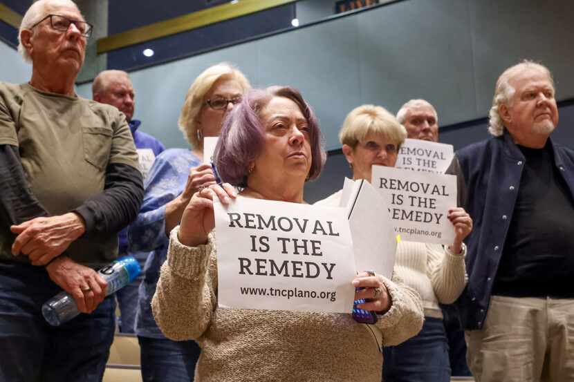 Plano resident Catherine Burns stands with those opposed to short-term rentals stand after...