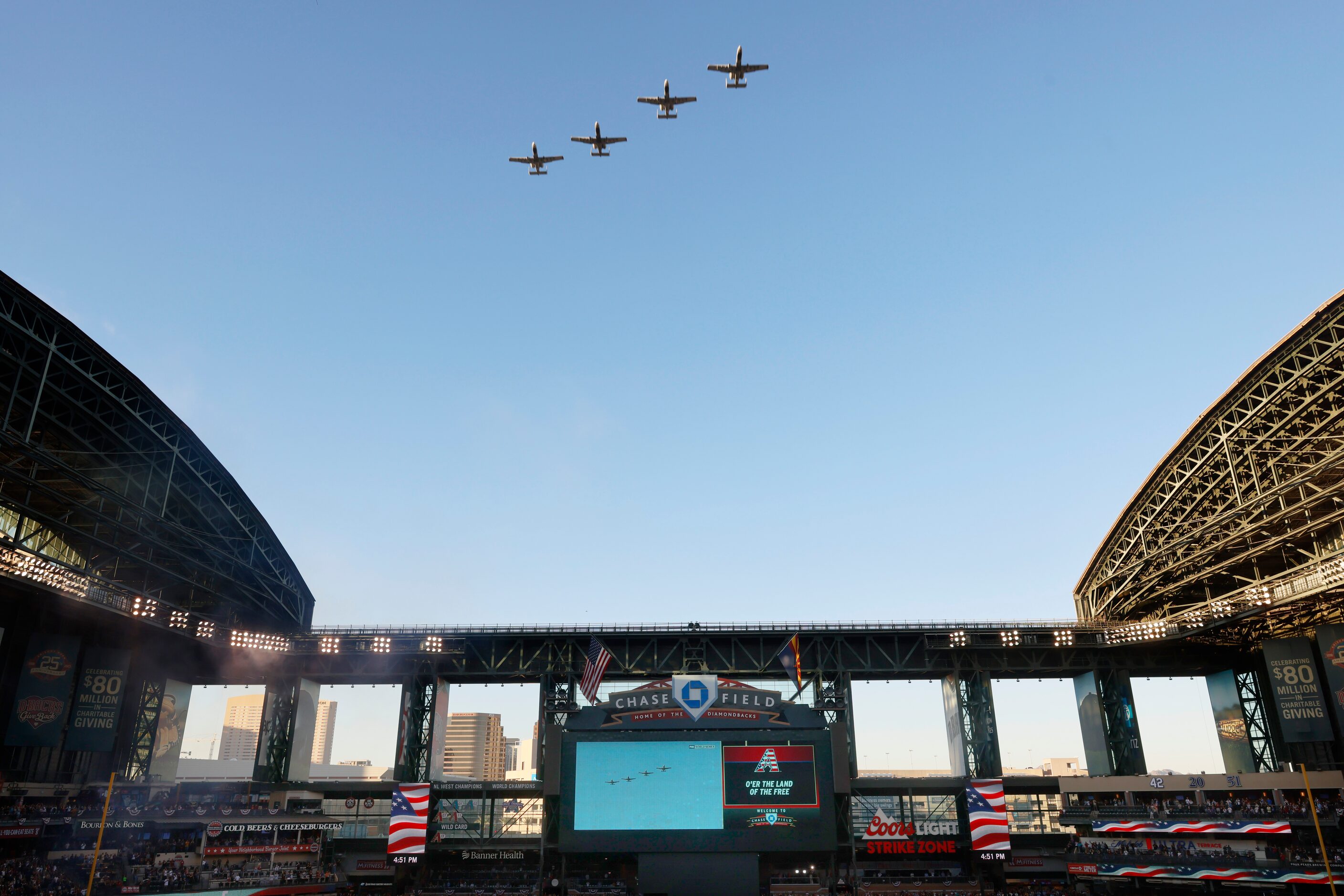 A-10 Warthogs fly over during the National Anthem before Game 4 of the World Series between...