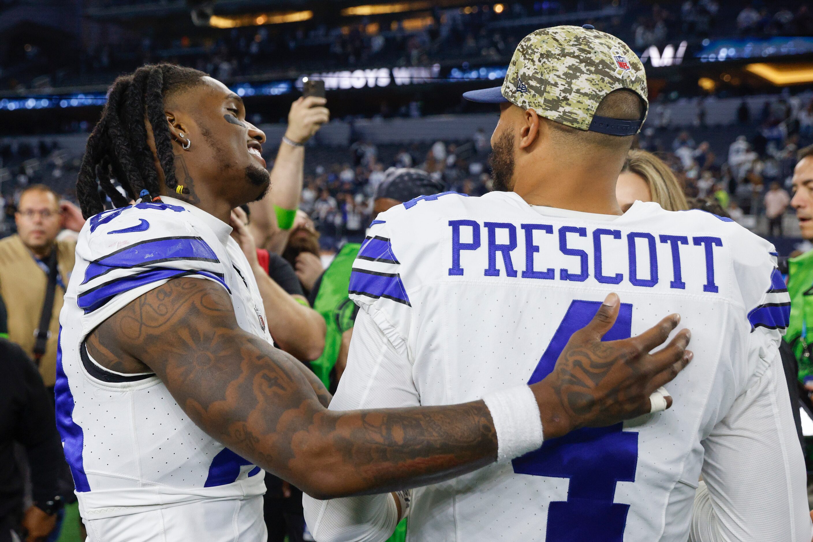 Dallas Cowboys wide receiver CeeDee Lamb (88) talks with quarterback Dak Prescott (4) after...