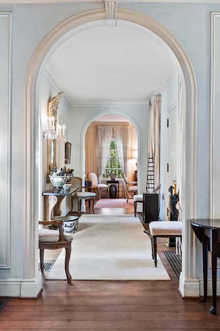 A central corridor connects the formal living room to the formal dining room. Elegant trim...