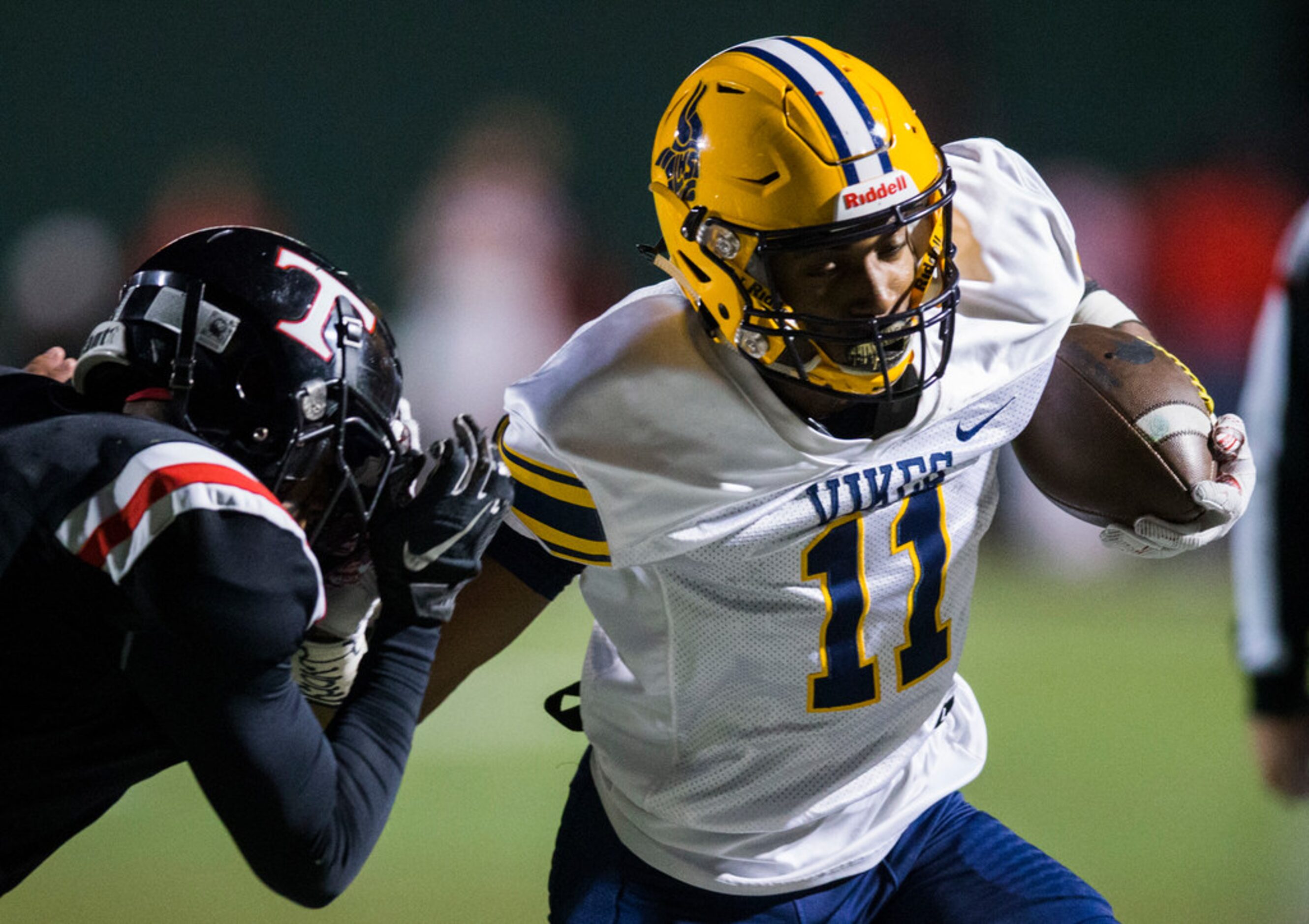 Arlington Lamar wide receiver Cam Brady (11) is pushed out of bounds by Euless Trinity...