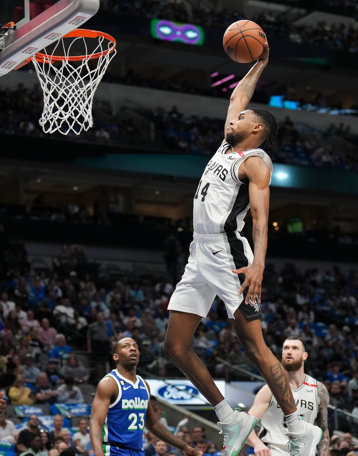 San Antonio Spurs guard Blake Wesley (14) dunks the ball as Dallas Mavericks guard McKinley...