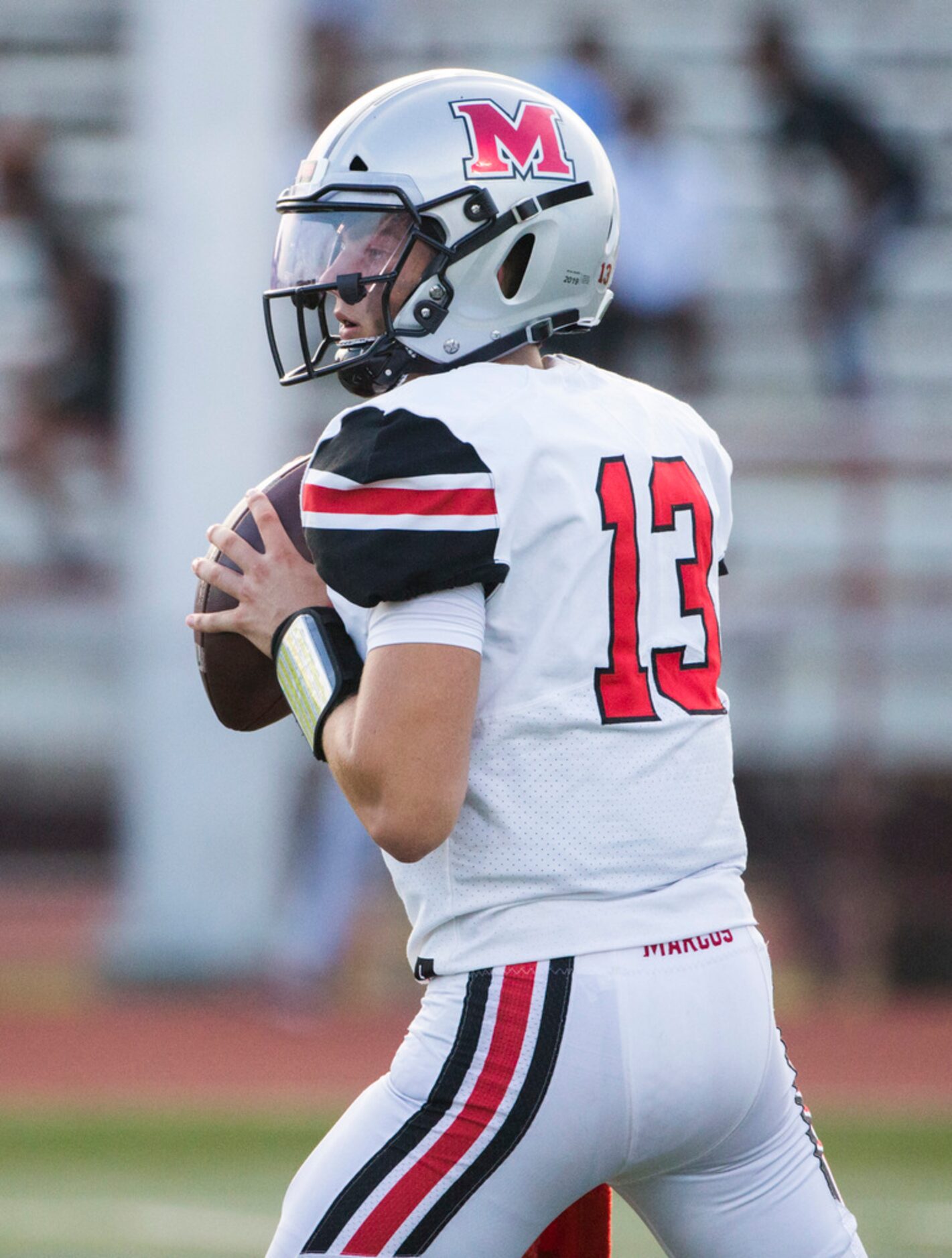 Flower Mound Marcus quarterback Garrett Nussmeier (13) looks for a receiver during the first...