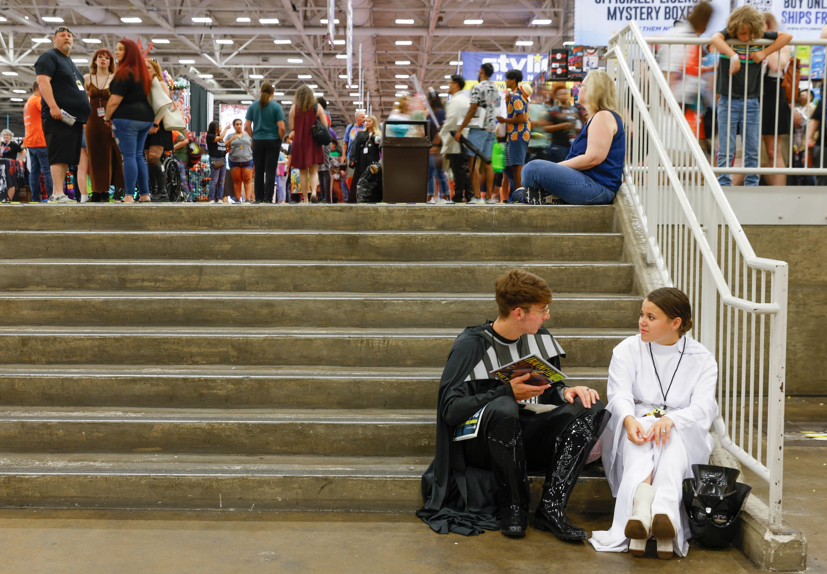 As people go around Michael and Elizabeth Hammack dressed as Star Wars character converse on...