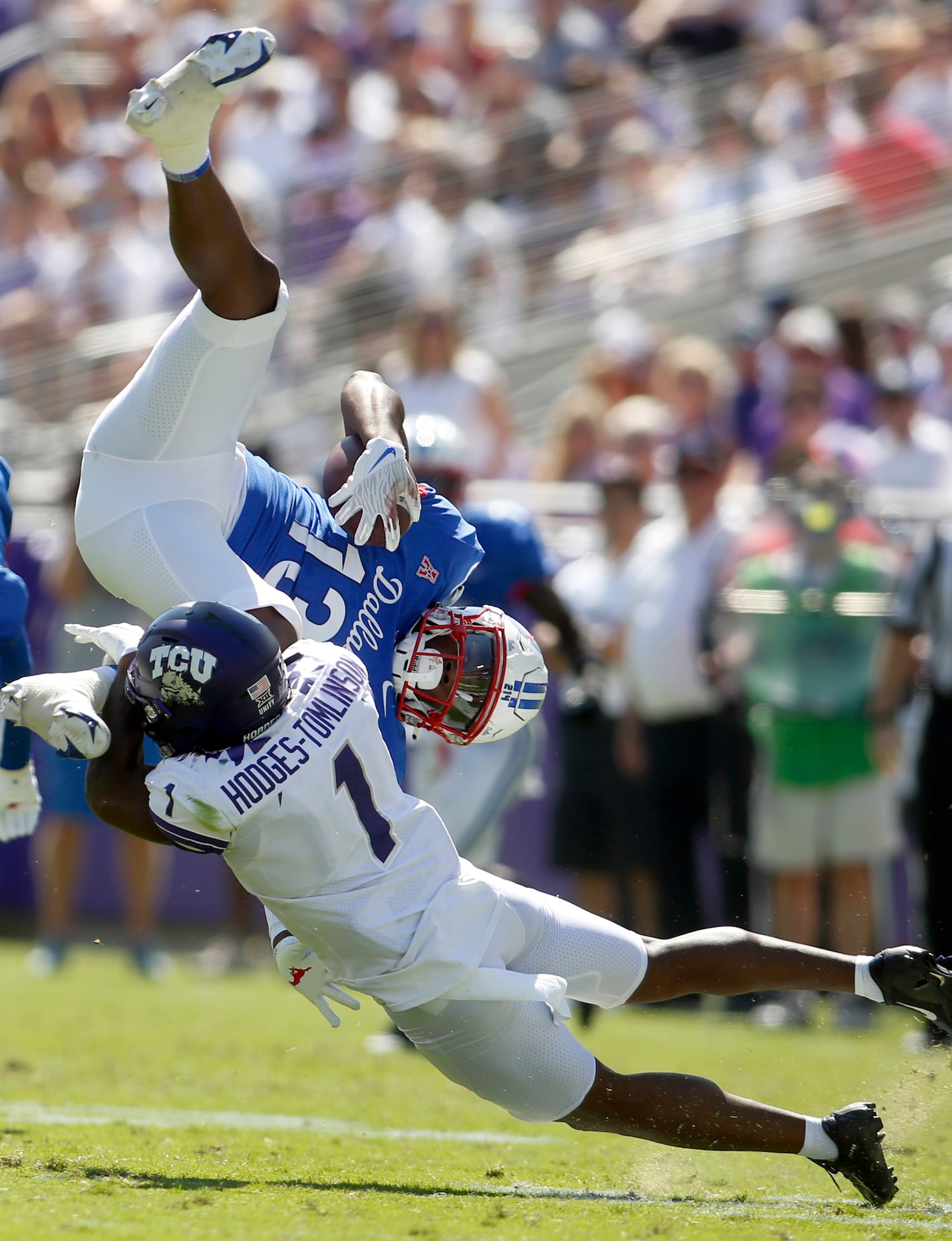 SMU receiver Roderick Daniels, Jr. (13) is upended by TCU cornerback Tri'Vius...