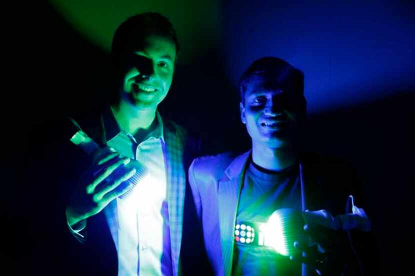 
Ilumi founders Corey Egan and Swapnil Bora show the prototype smart lightbulb. The LED...
