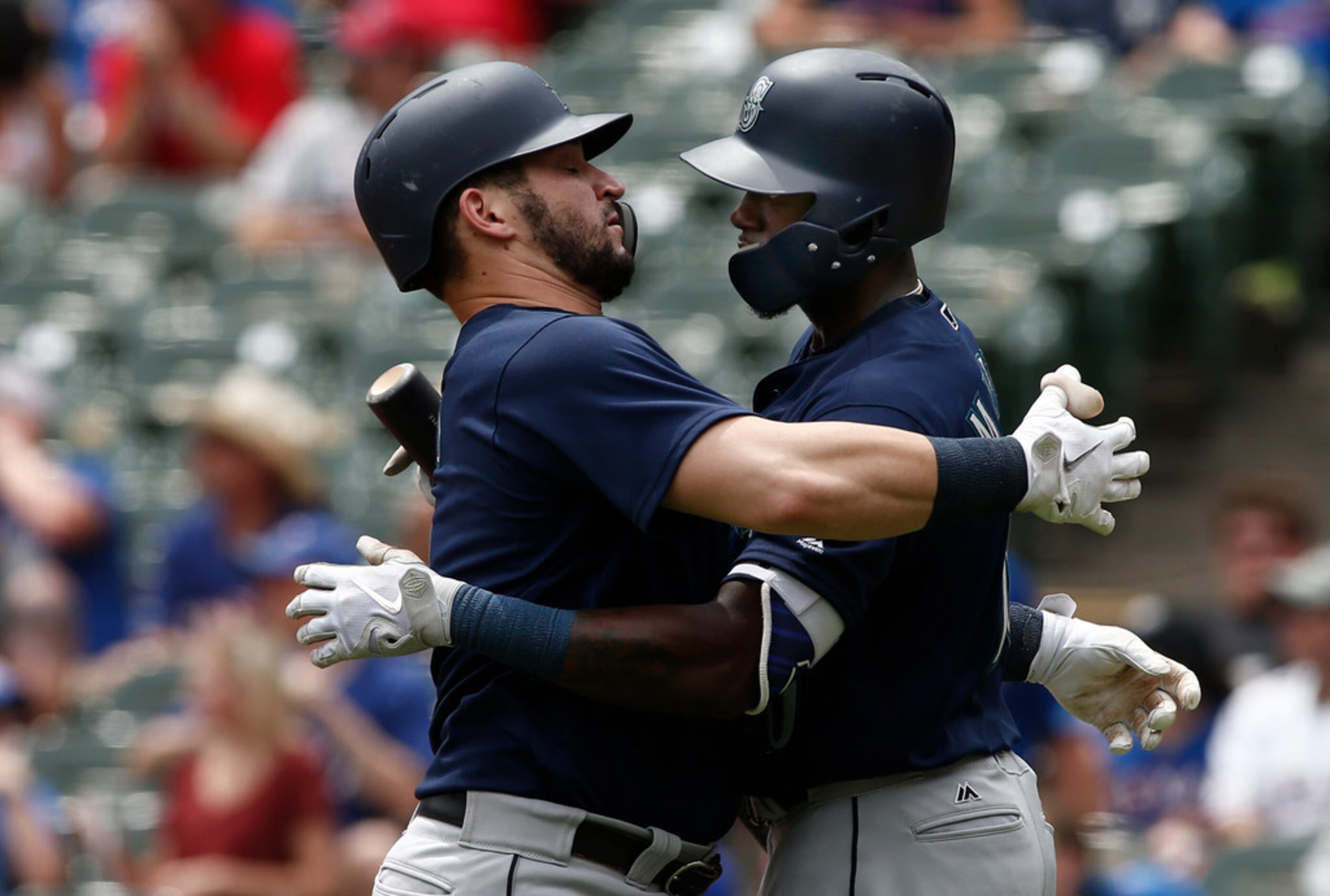 Seattle Mariners Mike Zunino, left, is congratulated by Dee Gordon after hitting a home run...