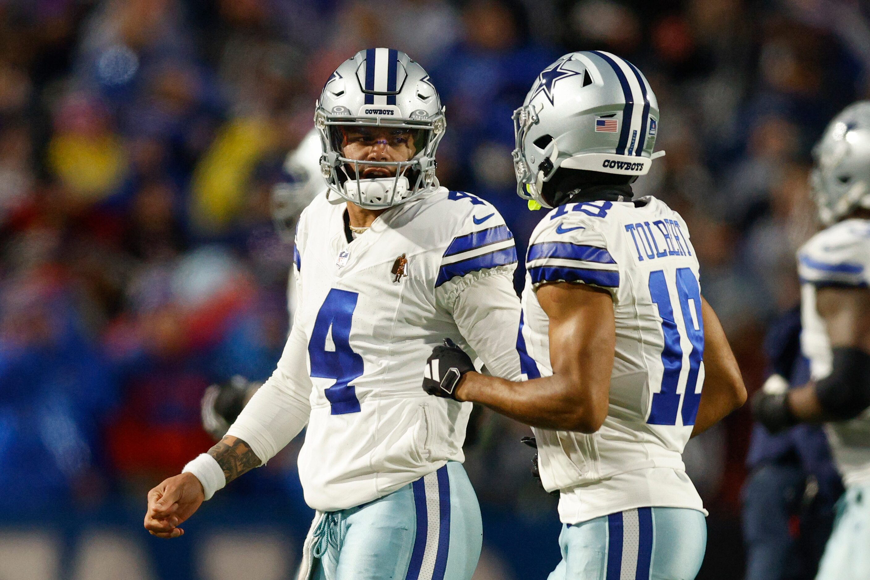 Dallas Cowboys quarterback Dak Prescott (4) talks with wide receiver Jalen Tolbert (18)...