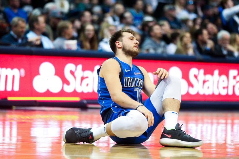 Dallas Mavericks forward Luka Doncic (77) collapse to the floor after getting a ball stolen...