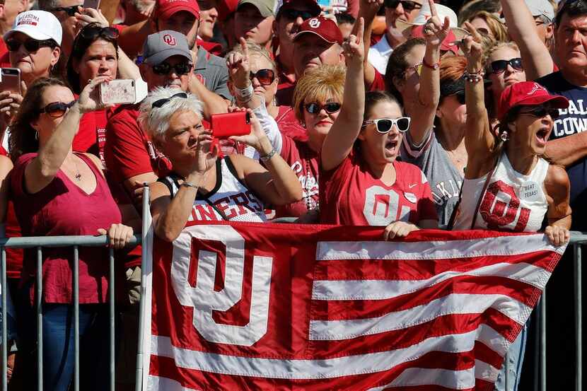 Sooner fans cheer as the team buses arrive before before Oklahoma visits Texas in the annual...