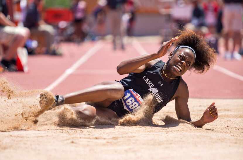 FILE - Mansfield Lake Ridge's Jasmine Moore reacts after completing a jump in the Girls 5A...