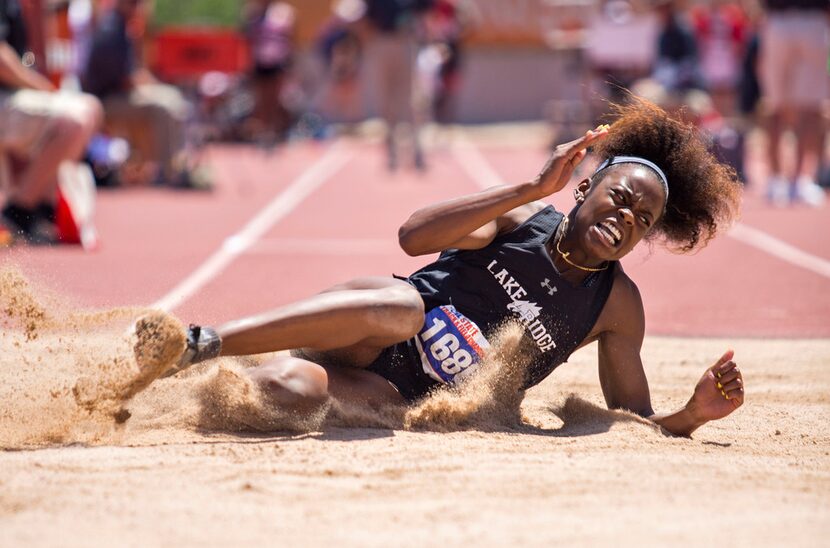 FILE - Mansfield Lake Ridge's Jasmine Moore reacts after completing a jump in the Girls 5A...