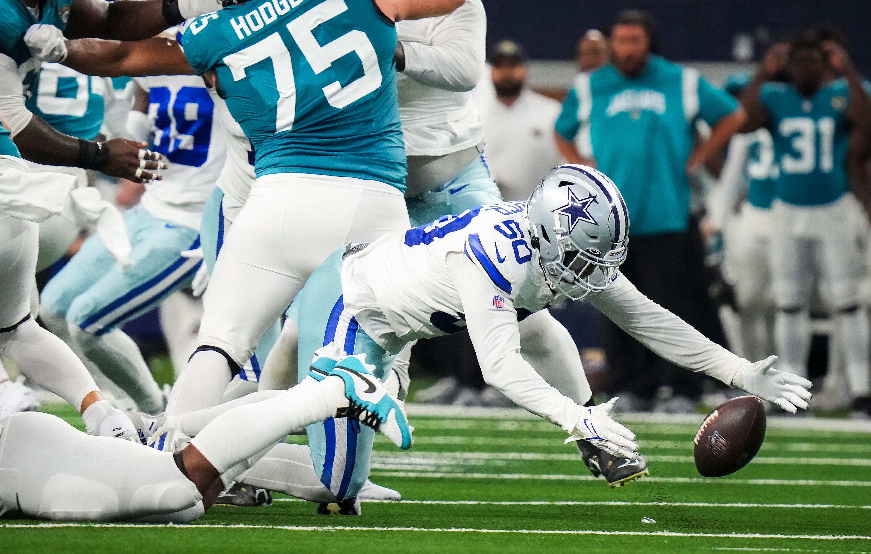 Dallas Cowboys linebacker Devin Harper (50) recovers a fumble by Jacksonville Jaguars...