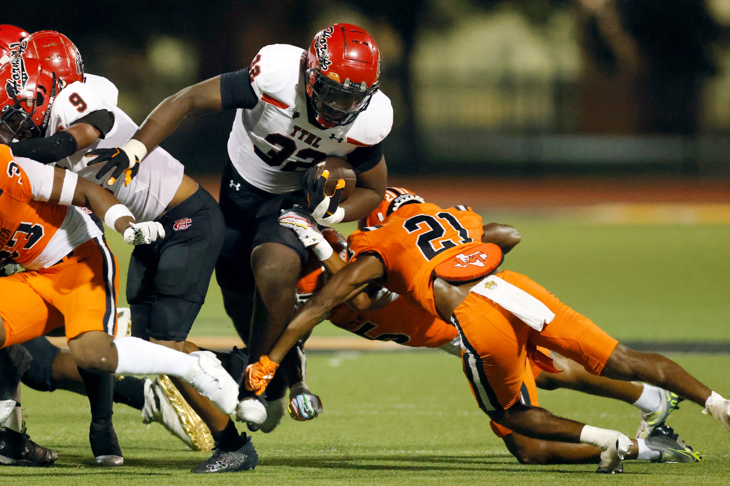 Cedar Hill running back Jalen Brewster (32) runs through the line of scrimmage as Lancaster...