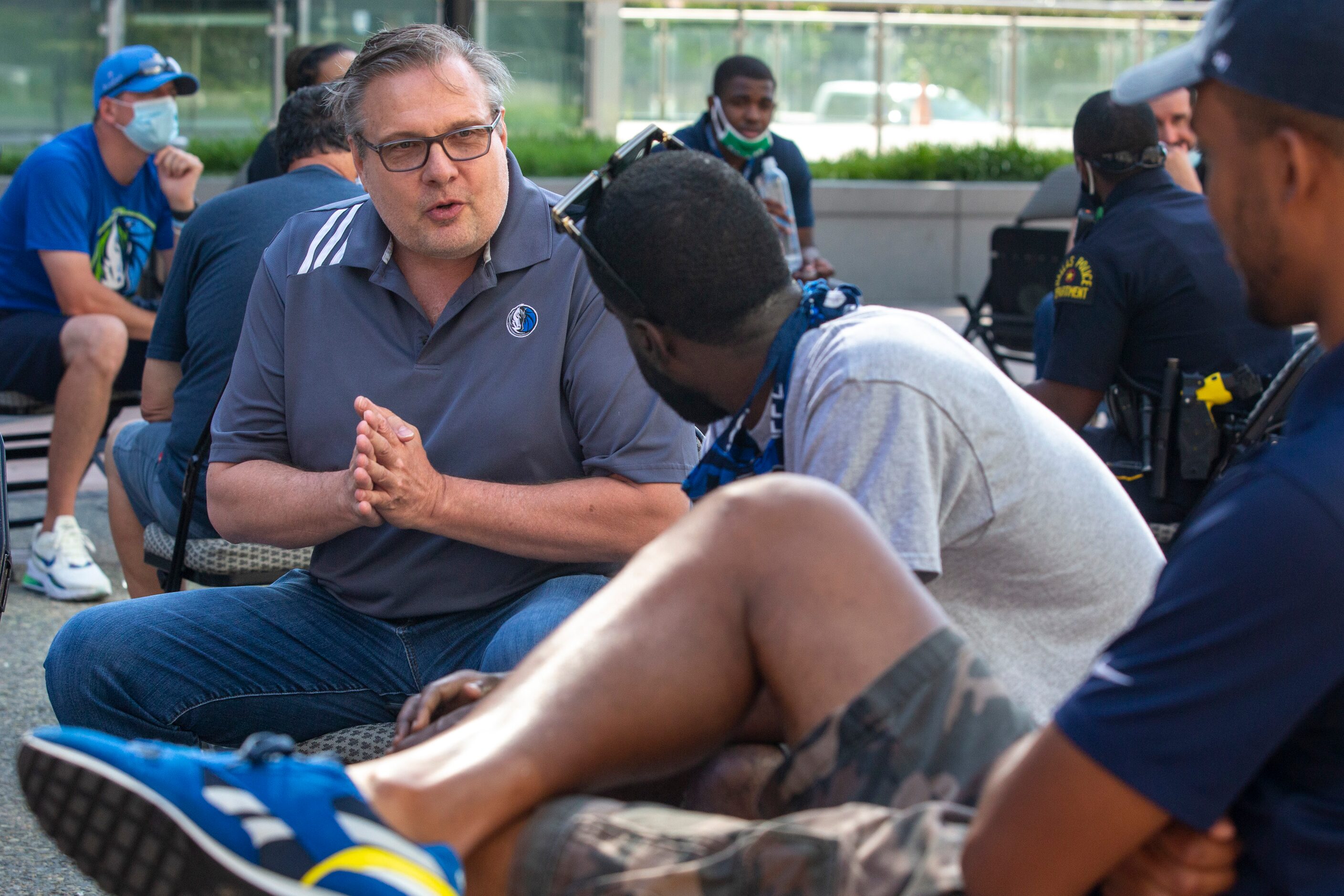 Dallas Mavericks General Manager Donnie Nelson speaks with other members of a small group...