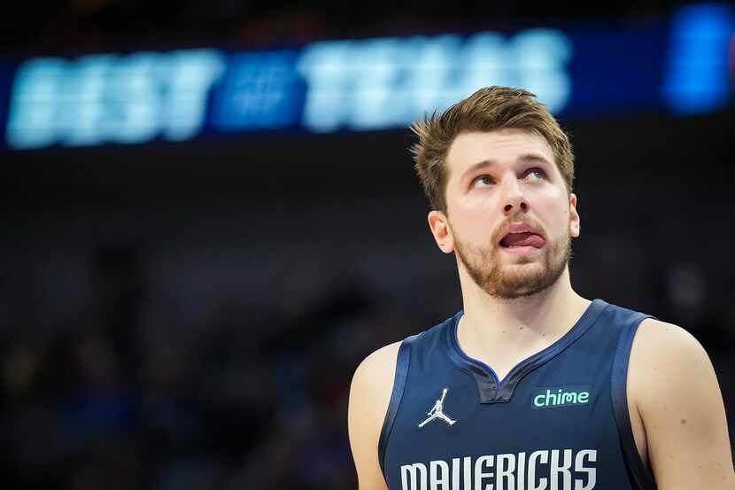 Dallas Mavericks guard Luka Doncic looks up at the scoreboard during the second half of an...