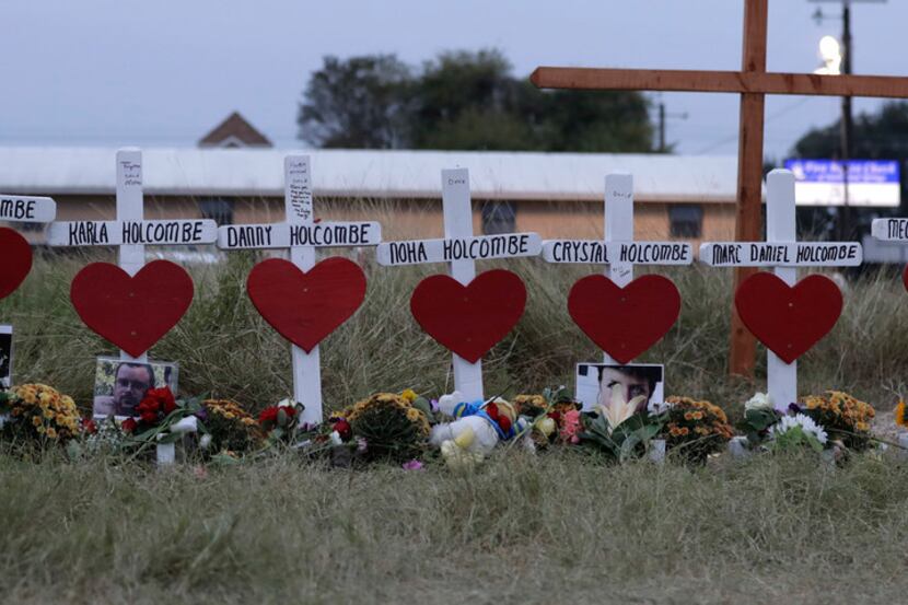 FILE - In this Nov. 10, 2017 file photo, crosses for members of the Holcombe family are part...