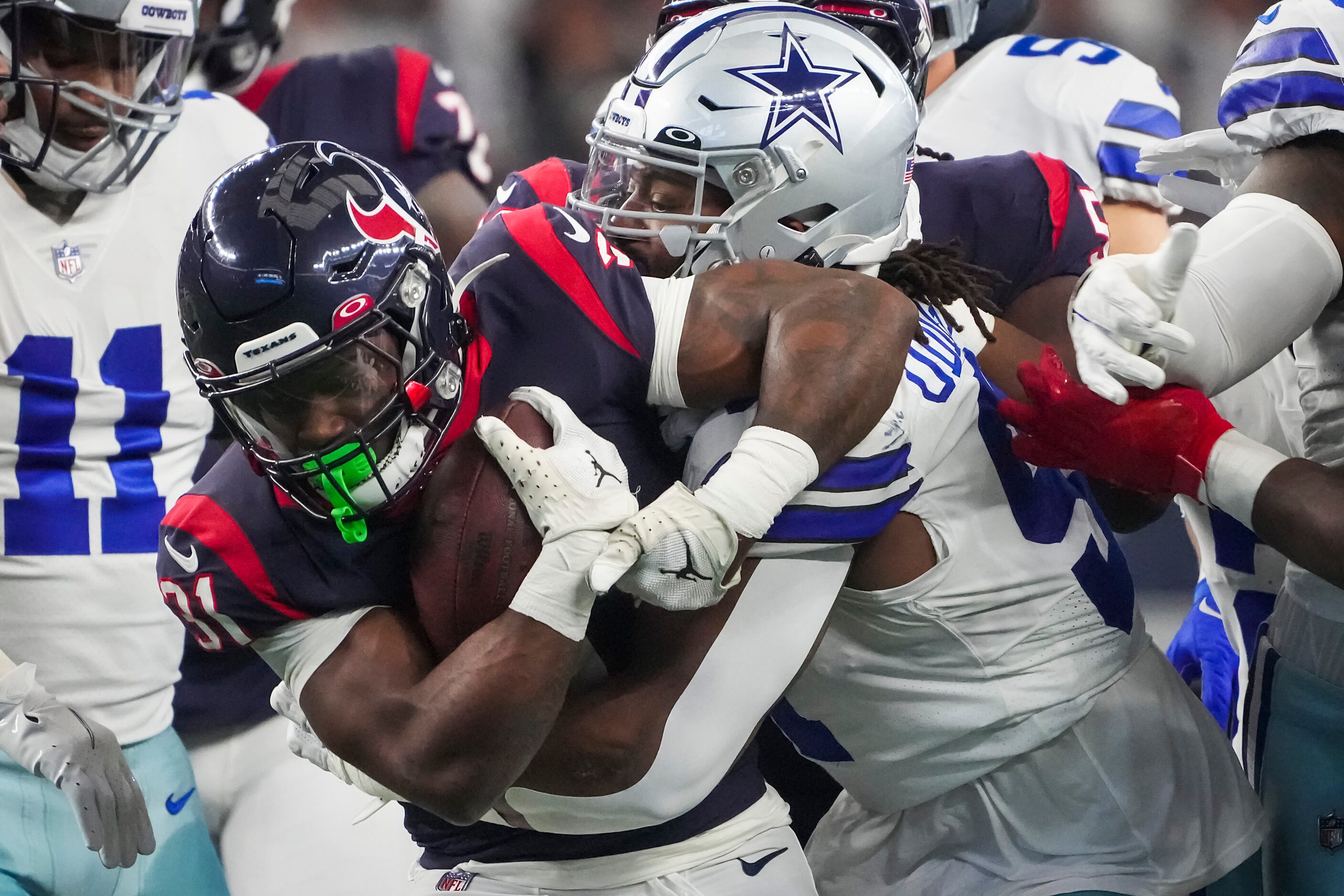 Houston Texans running back Dameon Pierce (31) is  brought down by Dallas Cowboys defensive...