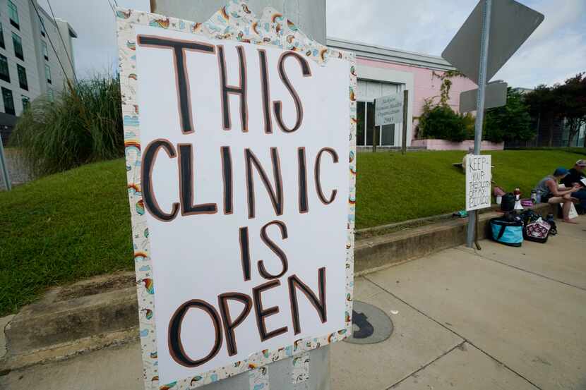 A posted sign outside the Jackson Women's Health Organization clinic assuree potential...