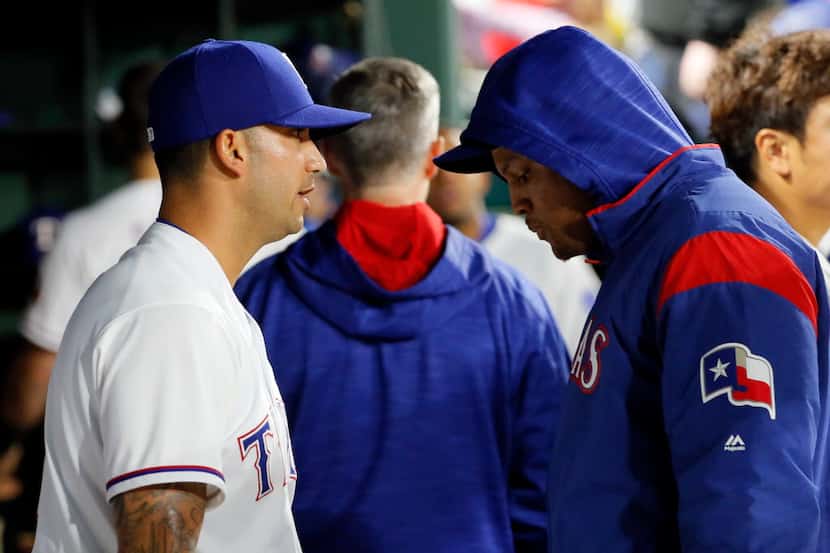 Texas Rangers' Matt Bush talks with Adrian Beltre, right, in the dugout after working...
