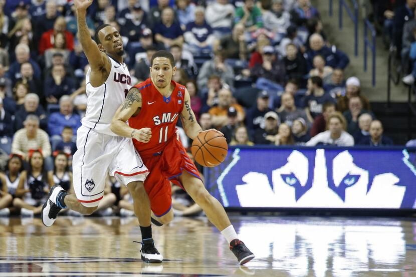 Feb 23, 2014; Storrs, CT, USA; Southern Methodist Mustangs guard Nic Moore (11) drives the...