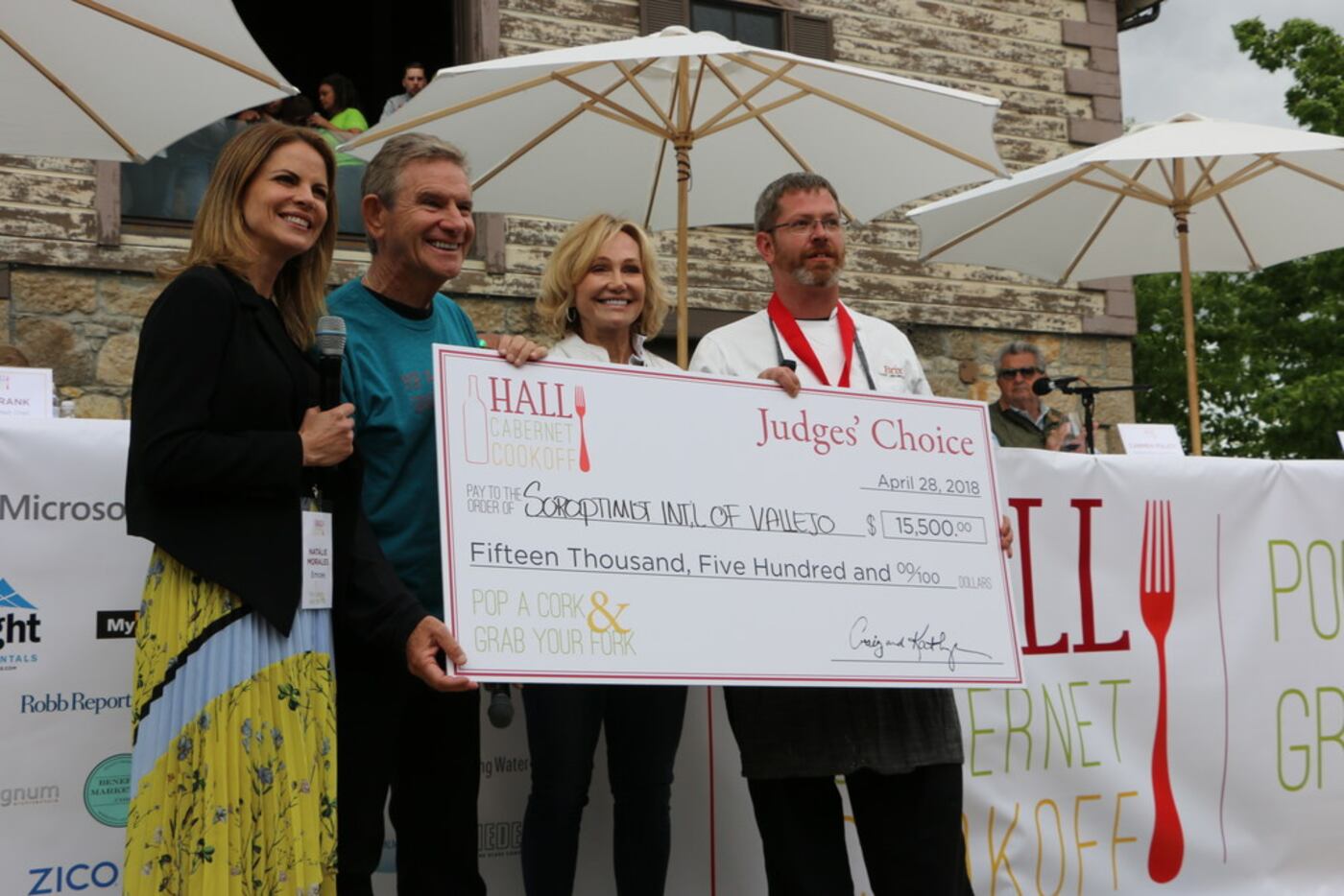 Natalie Morales, left, anchor of NBC's Today Show, and Craig and Kathryn Hall present check...
