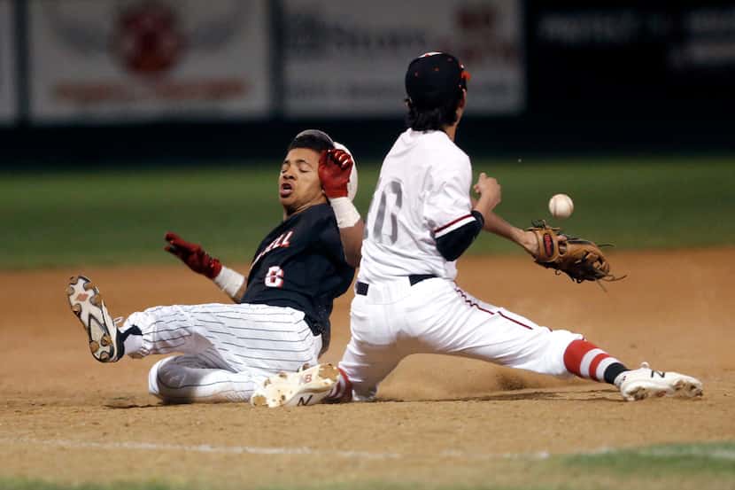 Coppell's De Heath (6) slides safely into third on an RBI triple as Lake Highlands third...