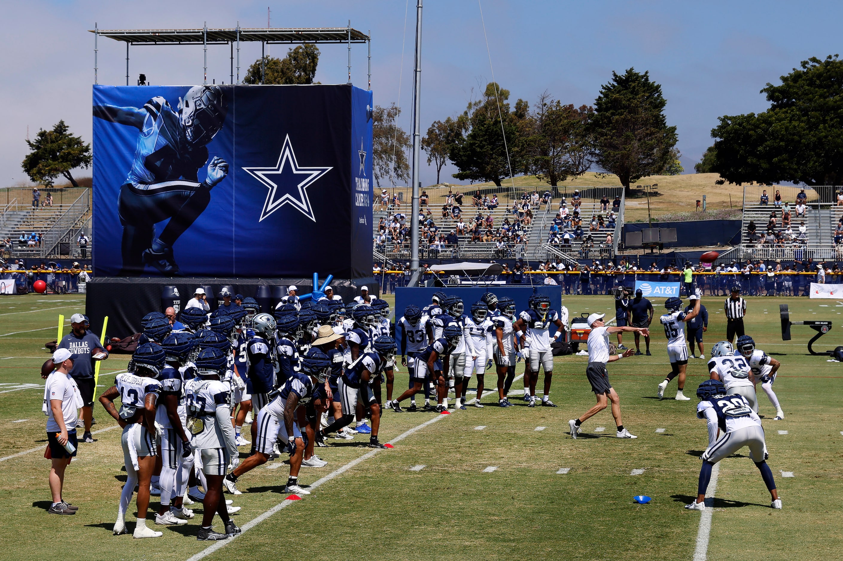 Dallas Cowboys special teams coach John Fassel throws the ball to start the new kickoff...