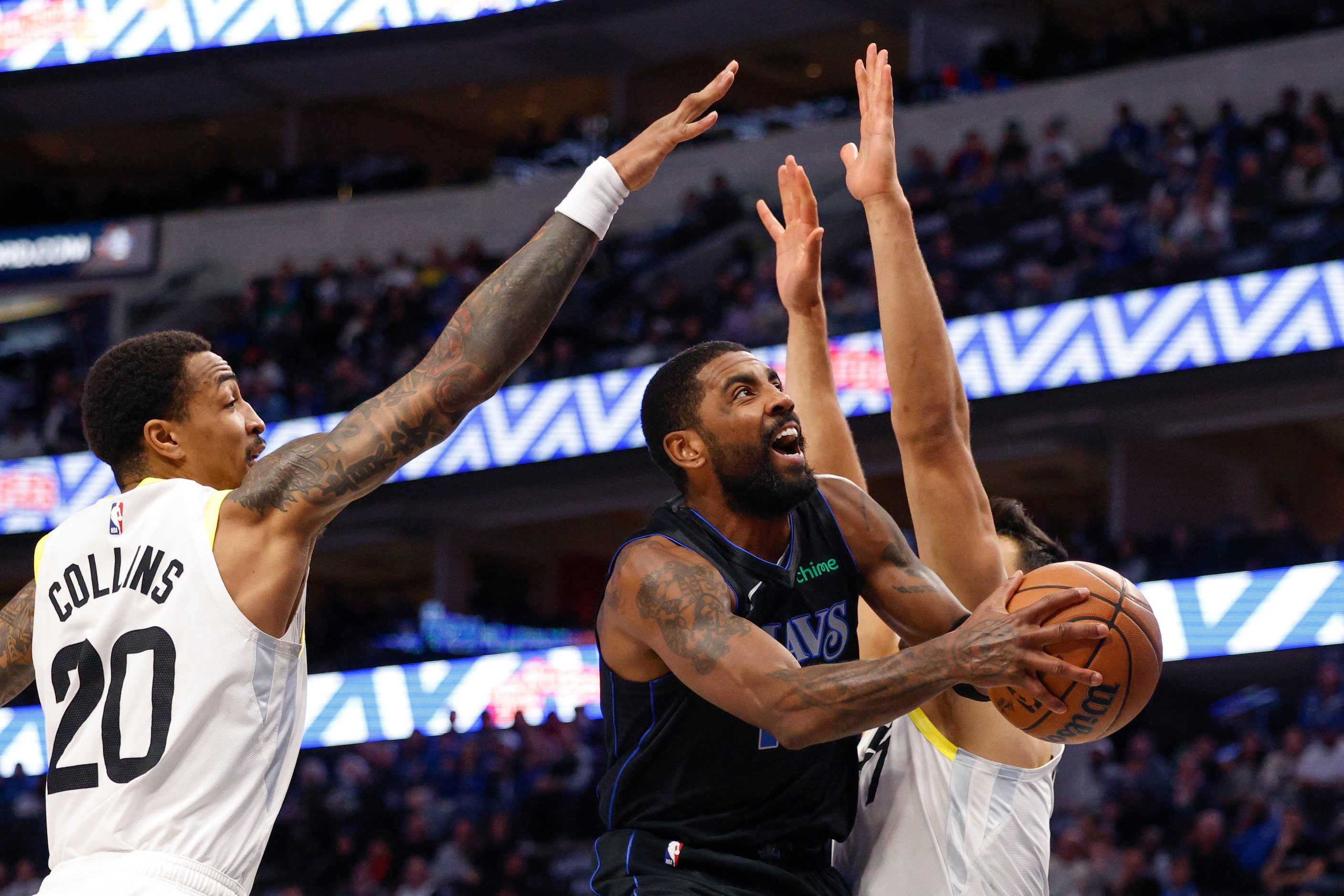 Dallas Mavericks guard Kyrie Irving (11) drives to the basket past Utah Jazz forward John...