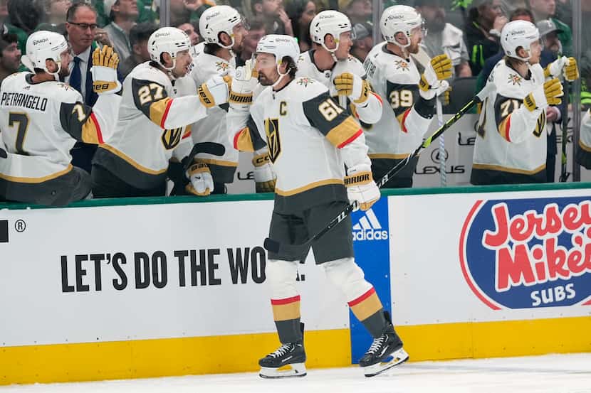Vegas Golden Knights right wing Mark Stone (61) celebrates with the bench after scoring in...