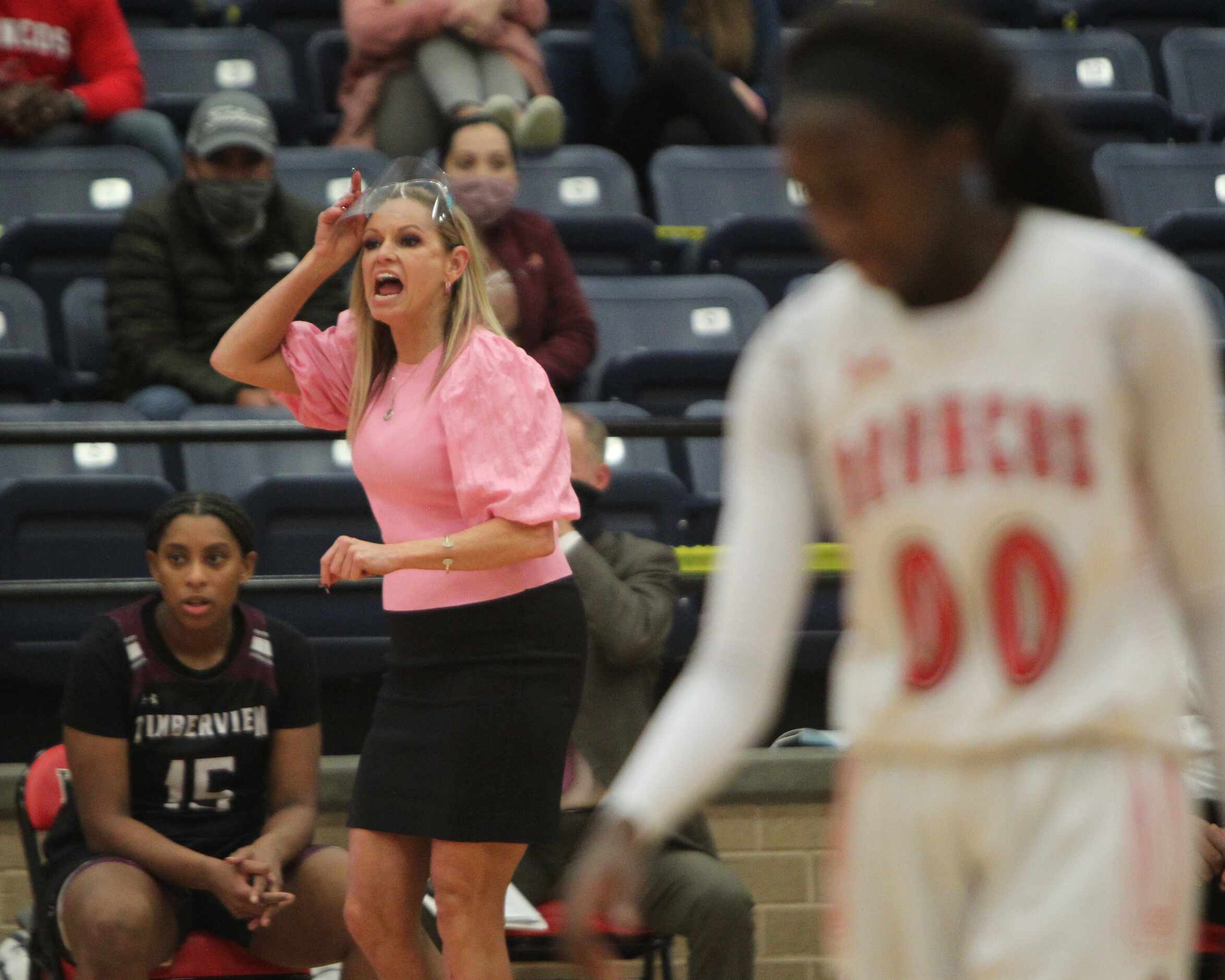 Mansfield Timberview head coach Kit Kyle Martin directs her players from the team bench area...