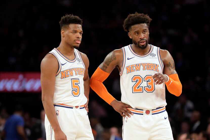 New York Knicks' Wesley Matthews, right, and Dennis Smith Jr. talk during the second half of...