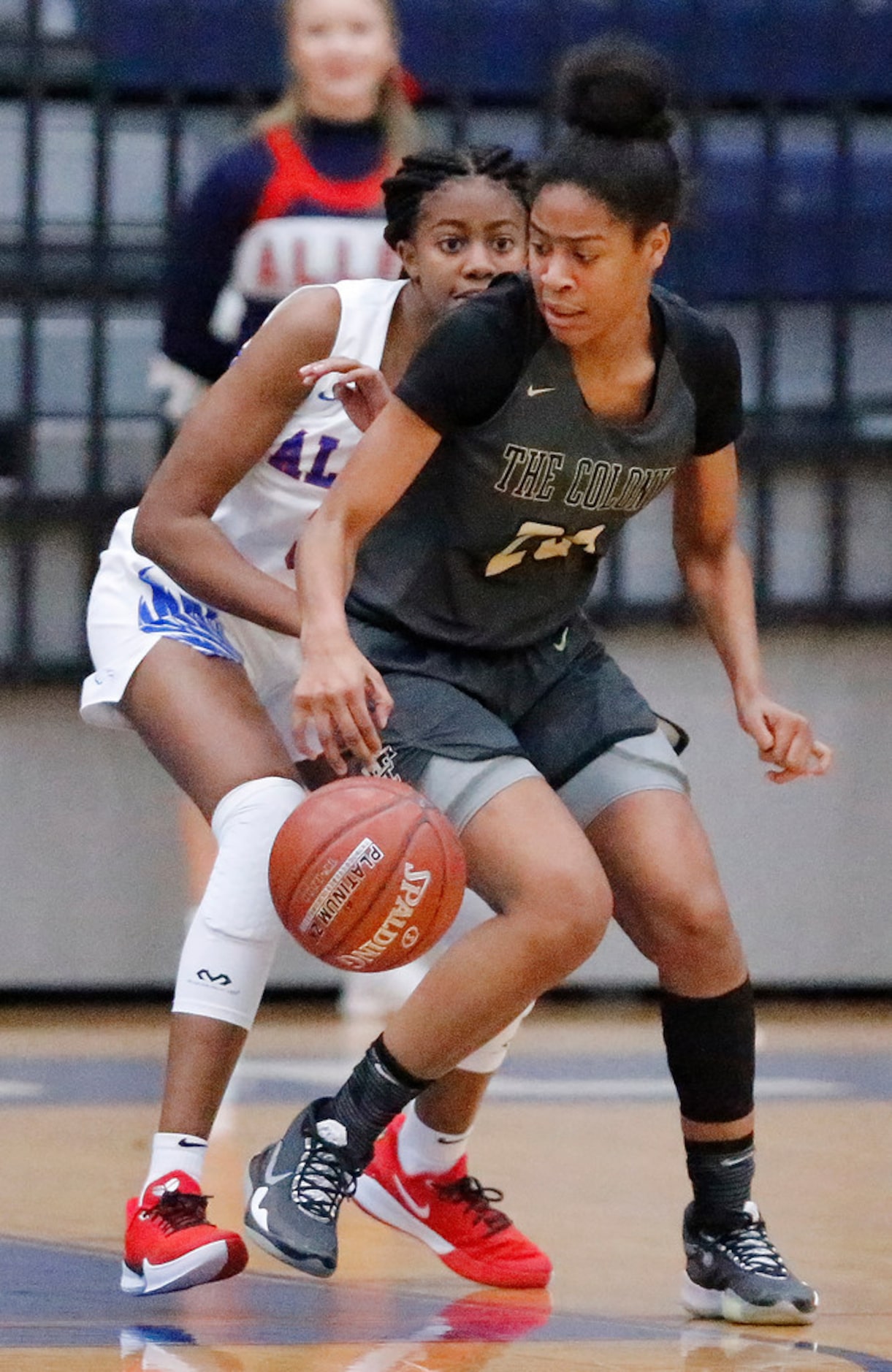 The Colony High Schoolâs Jewel Spear (23) does a spin move while Allen High Schoolâs...